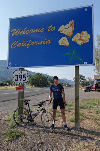 Me under the Welcome to California state sign