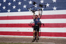 Holding my bike in front of a flag